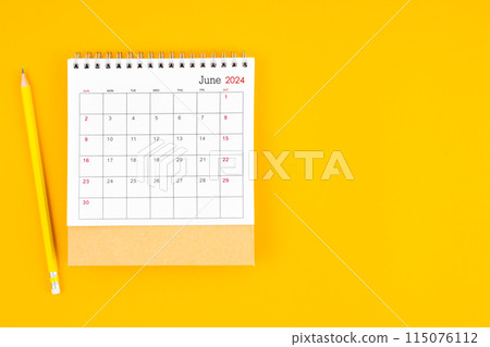 June 2024 desk calendar and wooden pencil on yellow color background. Time planning. June 2024 desk calendar and wooden pencil on yellow color background. Time planning. 115076112