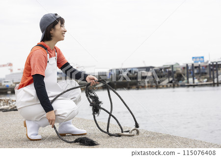 Woman working at the fish port 115076408