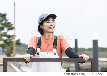 Young woman working at the fish port Young woman working at the fish port 115077226