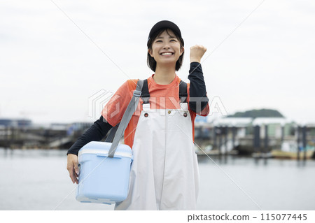 Young woman standing at a fishing port 115077445