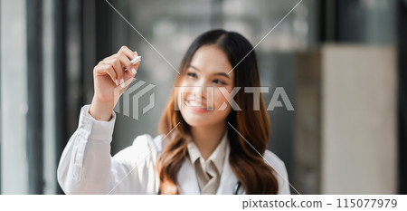 A woman in a white lab coat is holding a marker and drawing on a white board. She is smiling and she is enjoying herself. Concept of creativity and fun A woman in a white lab coat is holding a marker and drawing on a white board. She is smiling and she is enjoying herself. Concept of creativity and fun 115077979
