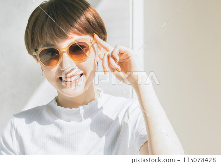 A woman wearing sunglasses 115078428
