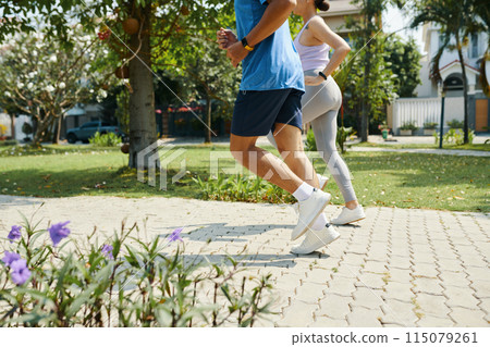 Couple Running Together in Park 115079261