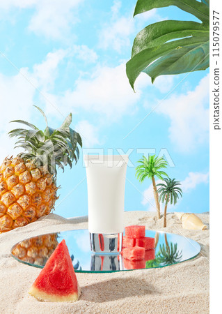 Photo has summer concept with tropical fruit and plants, a blank label tube placed on a glass pedestal next to some small pieces of melon, a pineapple, shell and coconut trees decorated in back 115079577