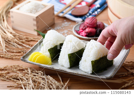 Freshly cooked rice wrapped in seaweed and rice and pickled plums served in a wooden box Freshly cooked rice wrapped in seaweed and rice and pickled plums served in a wooden box 115080143
