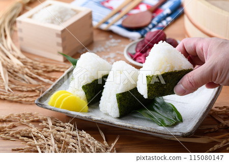 Freshly cooked rice wrapped in seaweed and rice and pickled plums served in a wooden box Freshly cooked rice wrapped in seaweed and rice and pickled plums served in a wooden box 115080147