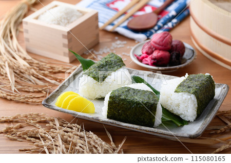 剛煮好的飯糰，裡麵包裹著海苔、米和酸梅，呈方形 115080165