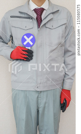 A man in work clothes holding a cross sign | Images of NGs and incorrect answers in the construction and manufacturing industries 115080575