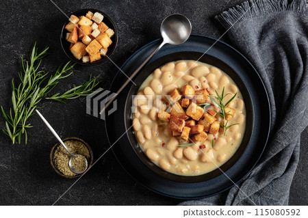 rosemary garlic creamy white bean soup in bowl 115080592