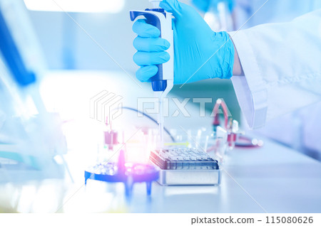 Male scientist working at the laboratory. Cloud up medical hand using micro pipette for test analysis. Scientific Lab for Medicine, Biotechnology Researchers. 115080626