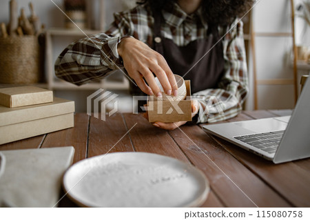 Entrepreneur sells dishes, plates and cups made of clay Entrepreneur sells dishes, plates and cups made of clay 115080758