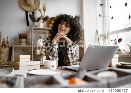 Happy female saleswoman waiting for customers. Happy female saleswoman waiting for customers. 115080777