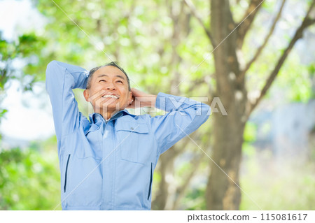 Man in work clothes stretching 115081617