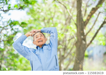 Man in work clothes stretching 115081619
