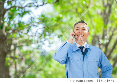 穿著工作服的男人用智慧型手機交談 115081675
