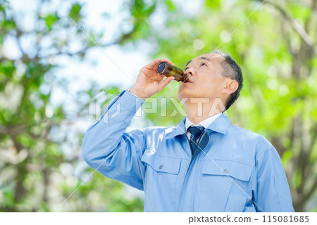 Man in work clothes Energy drink Man in work clothes Energy drink 115081685