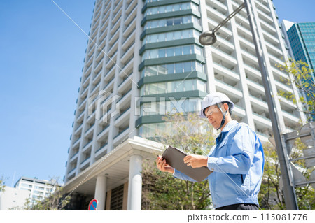 Man in work clothes, office building, tablet, landscape orientation 115081776