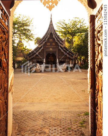 Old Temple in Chiang Mai, Thailand. Old Lanna temple - Wat Pan Sao and carved wood gate 115082435