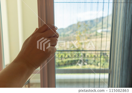 Hand hold pleated mosquito net wire screen handle on house window 115082863