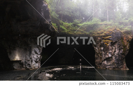 Abandoned empty marble quarry on a rainy summer day. Ruskeala Abandoned empty marble quarry on a rainy summer day. Ruskeala 115083473