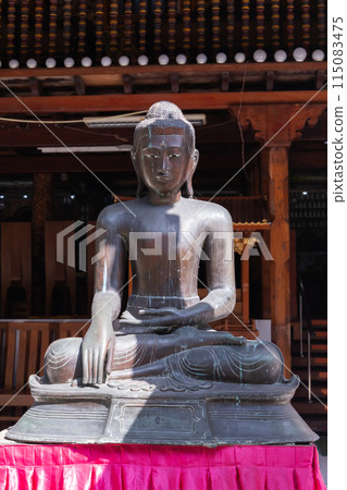 Ancient Buddha statue at Gangaramaya Temple, Colombo Ancient Buddha statue at Gangaramaya Temple, Colombo 115083475
