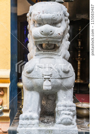 Front view of a stone guard lion statue at Gangaramaya Temple Front view of a stone guard lion statue at Gangaramaya Temple 115083487