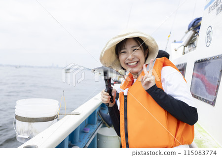 Cute woman enjoying fishing Cute woman enjoying fishing 115083774