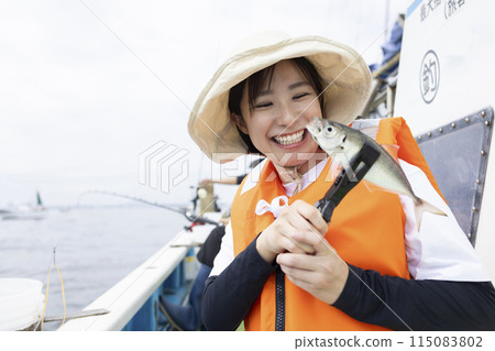 Cute woman enjoying fishing Cute woman enjoying fishing 115083802