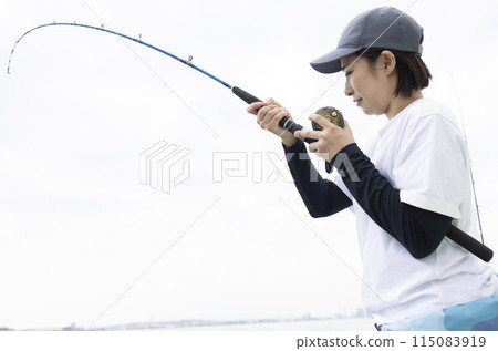Cute woman enjoying fishing Cute woman enjoying fishing 115083919