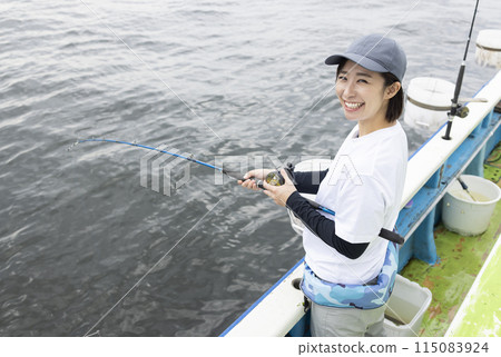 Cute woman enjoying fishing 115083924