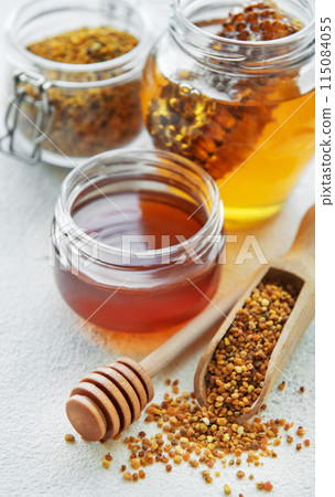 Raw organic bee pollen and honey in jars. 115084055