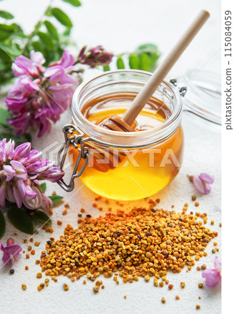 Raw organic bee pollen and honey in jars. Raw organic bee pollen and honey in jars. 115084059
