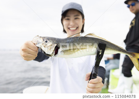 Cute woman enjoying fishing Cute woman enjoying fishing 115084078