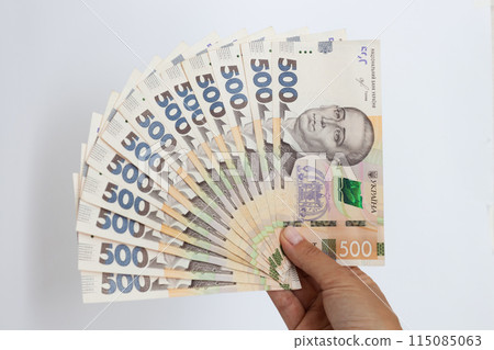 Ukrainian money. Ukrainian 500 banknotes in a female hand. 115085063