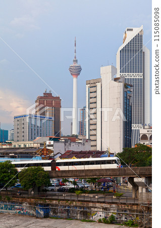 Subway train on a elevated railroad track passing in front of the Kuala Lumpur Tower Subway train on a elevated railroad track passing in front of the Kuala Lumpur Tower 115085098