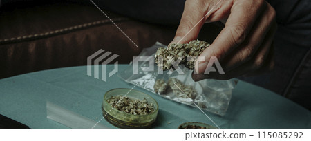 man with a cannabis bud in his hand, banner man with a cannabis bud in his hand, banner 115085292