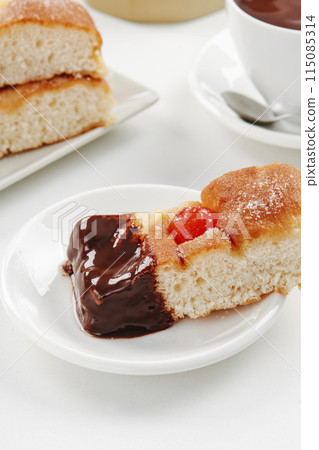catalan coca de sant joan dipped in hot chocolate 115085314