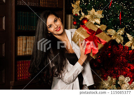 Beautiful young woman in sexual black lingerie posing in Christmas decorations. Beautiful young woman in sexual black lingerie posing in Christmas decorations. 115085377