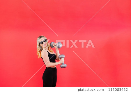Woman, portrait and fitness, sunglasses and dumbbells, retro fashion accessory and muscle training. Woman, portrait and fitness, sunglasses and dumbbells, retro fashion accessory and muscle training. 115085432