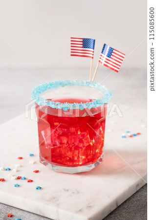 Patriotic red pomegranate margarita on blue background. Vertical format. Close up. 115085600