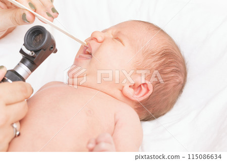 Doctor Examining Newborns Mouth Doctor Examining Newborns Mouth 115086634