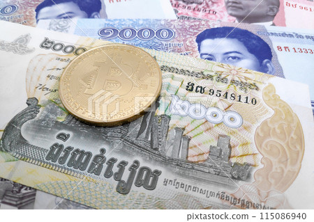 Bitcoin on a stack of Cambodian riel banknotes 115086940
