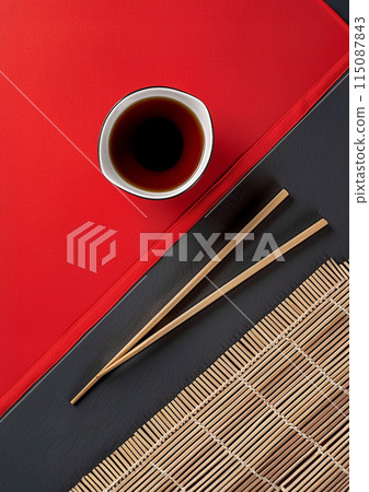Two chopsticks and bamboo mat on cement background. Top view, copy space. 115087843