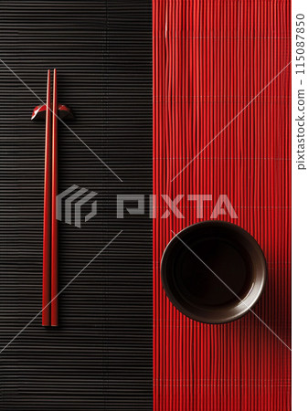 Two chopsticks and bamboo mat on cement background. Top view, copy space. 115087850