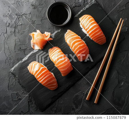 Sushi set with wasabi and ginger on black stone tray on black table. Top view. Sushi set with wasabi and ginger on black stone tray on black table. Top view. 115087879