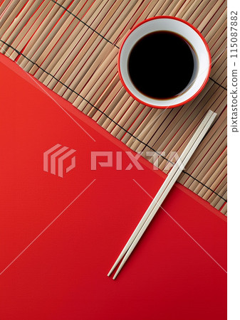 Two chopsticks and bamboo mat on cement background. Top view, copy space. 115087882