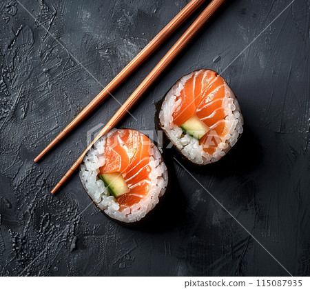Minimal layout flat lay sushi with salmon on black plate over black background Minimal layout flat lay sushi with salmon on black plate over black background 115087935