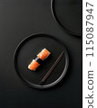 Minimal layout flat lay sushi with salmon on black plate over black background 115087947