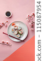 Aesthetic flat lay sushi plate with chopsticks over pink background with sakura branches as decor 115087954