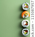Set of sushi rolls top view over soft green background 115087957